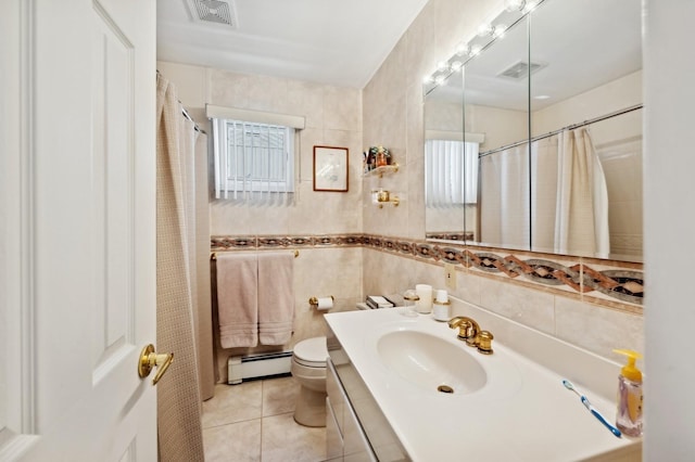 full bath with a baseboard heating unit, tile patterned flooring, visible vents, and tile walls