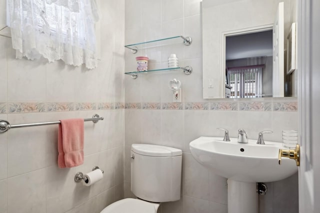 bathroom with tile walls and toilet