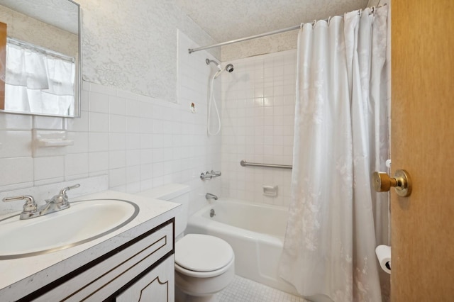 bathroom featuring shower / bath combo, toilet, a textured ceiling, vanity, and tile walls