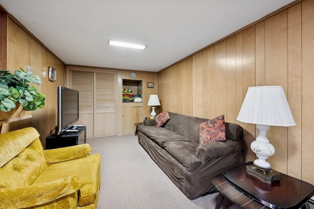 living area with wooden walls and carpet flooring