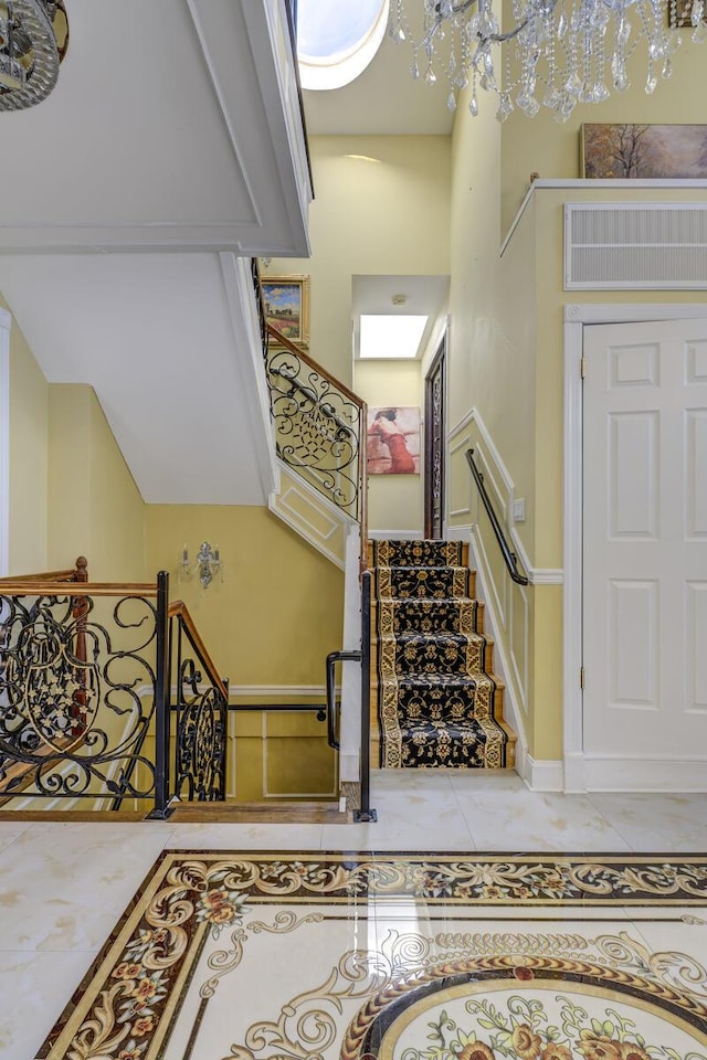 stairway with baseboards and tile patterned floors