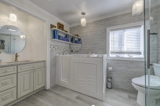 laundry room featuring washing machine and dryer, laundry area, a sink, tile walls, and crown molding