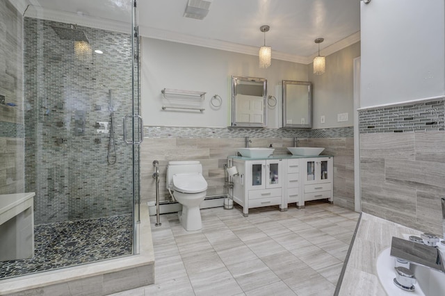 bathroom featuring crown molding, a sink, a shower stall, and toilet