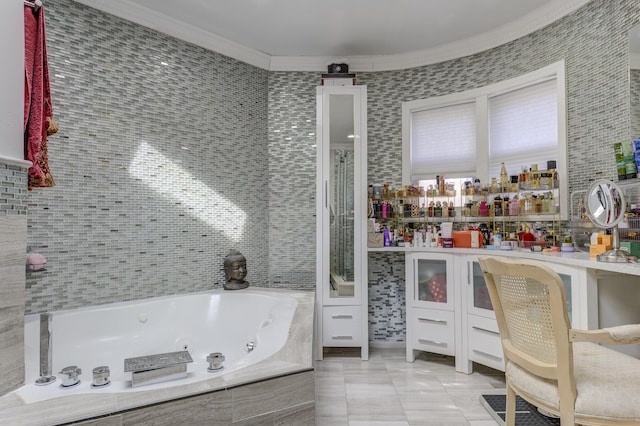 full bath with ornamental molding, a jetted tub, tile patterned flooring, vanity, and tile walls