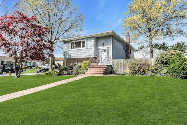 view of front of home with a chimney and a front yard