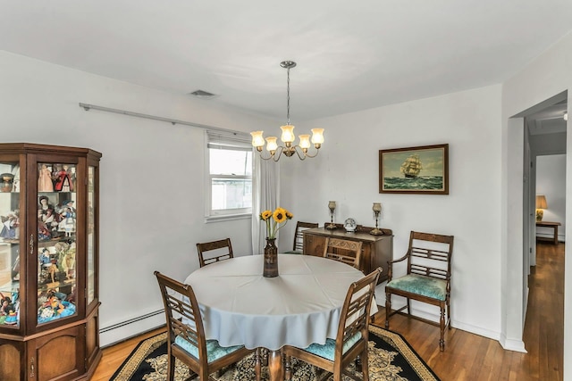 dining space with visible vents, a baseboard radiator, light wood finished floors, and a notable chandelier