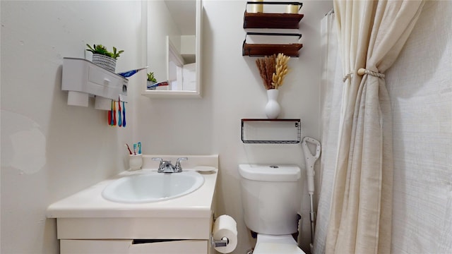 bathroom featuring toilet and vanity