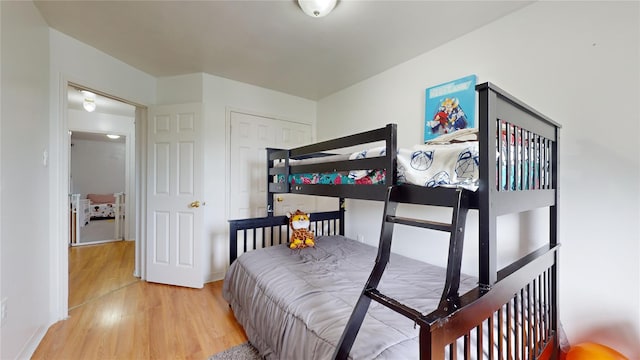 bedroom with baseboards and wood finished floors