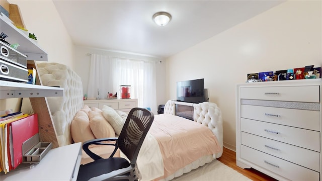 bedroom featuring wood finished floors