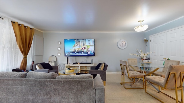 living area featuring baseboards and ornamental molding