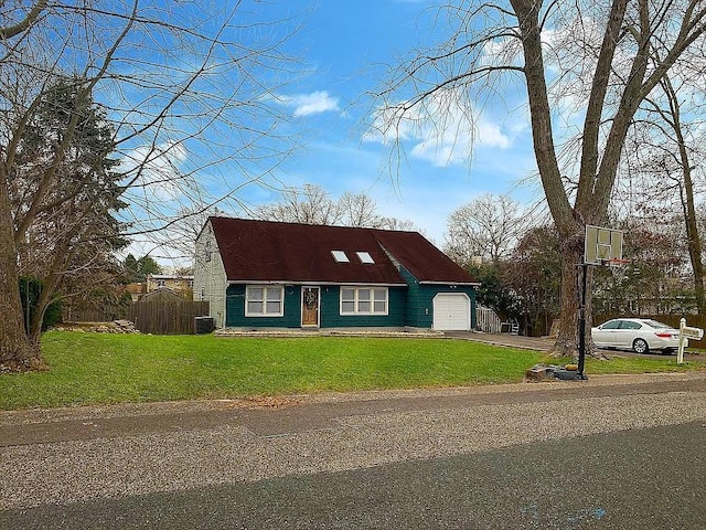 view of front of property with a garage, driveway, fence, and a front yard