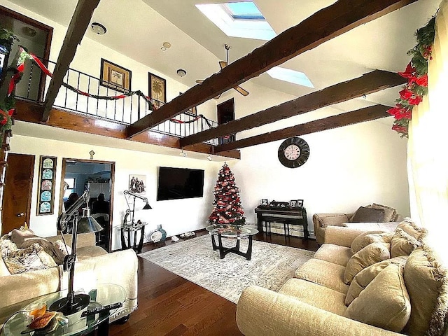 living room featuring high vaulted ceiling, beamed ceiling, a skylight, and wood finished floors