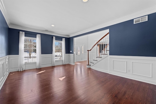 interior space with dark wood-style floors, visible vents, ornamental molding, and stairway