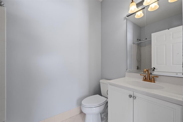 full bath with baseboards, a shower, toilet, tile patterned flooring, and vanity