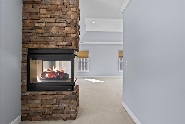 carpeted living room featuring baseboards and a multi sided fireplace