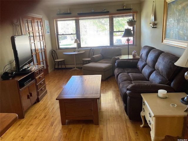 living room with light wood-style flooring and baseboard heating