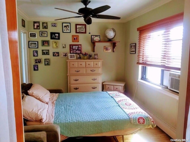 bedroom featuring ceiling fan, cooling unit, and crown molding