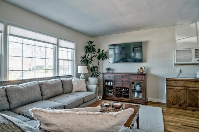 living room with baseboards and wood finished floors