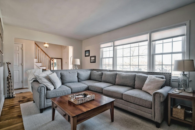 living room with stairway and dark wood-type flooring