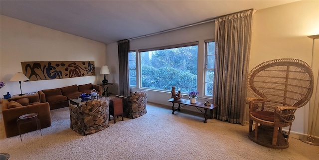 living area featuring carpet and lofted ceiling