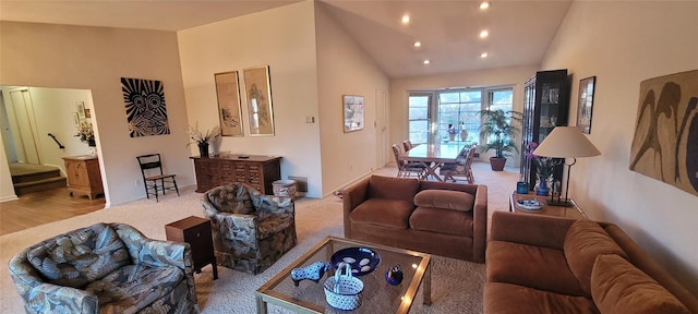 living area with high vaulted ceiling, carpet, and recessed lighting