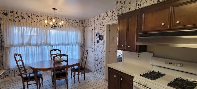 dining room featuring wallpapered walls and an inviting chandelier