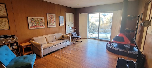 living area with wooden walls and wood finished floors