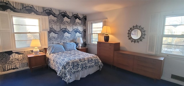 bedroom featuring visible vents and wallpapered walls