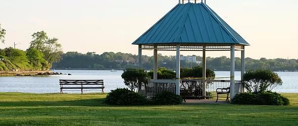 surrounding community with a gazebo, a lawn, and a water view