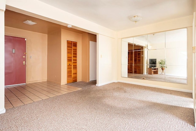 carpeted empty room with tile patterned floors