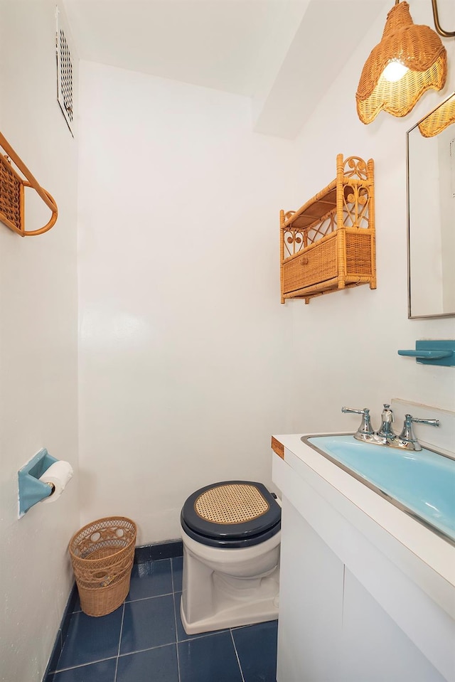 bathroom featuring visible vents, toilet, tile patterned flooring, and vanity