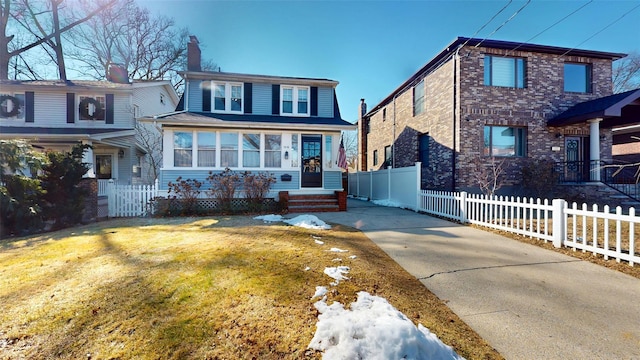 view of front of house with fence and a front lawn