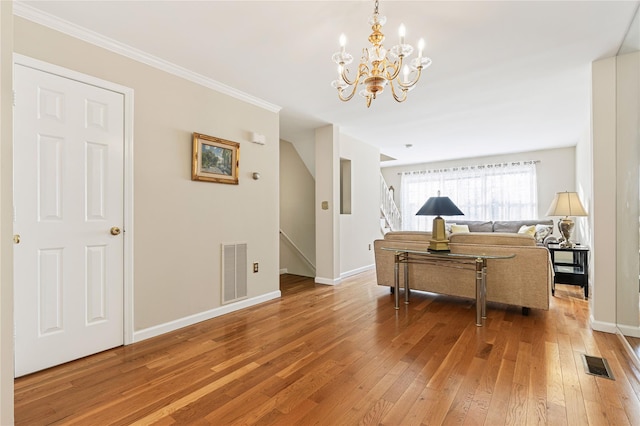 living room with baseboards, stairway, visible vents, and light wood-style floors