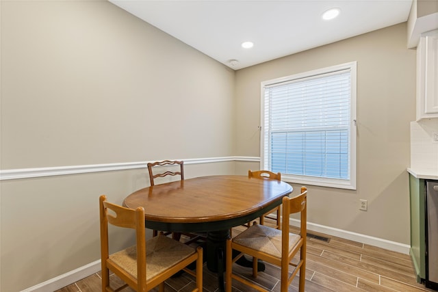 dining area with light wood finished floors, recessed lighting, and baseboards