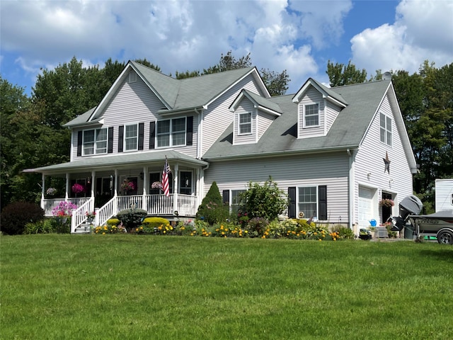 view of front of home featuring a porch, an attached garage, and a front lawn