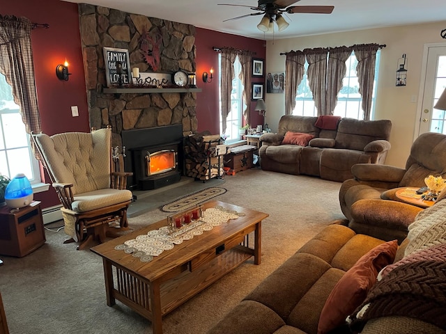 living area with a baseboard radiator, carpet flooring, a wealth of natural light, and a ceiling fan