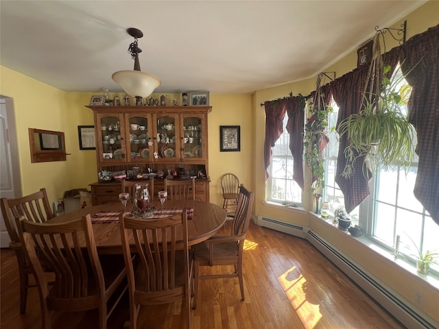 dining room with light wood-style flooring and baseboard heating