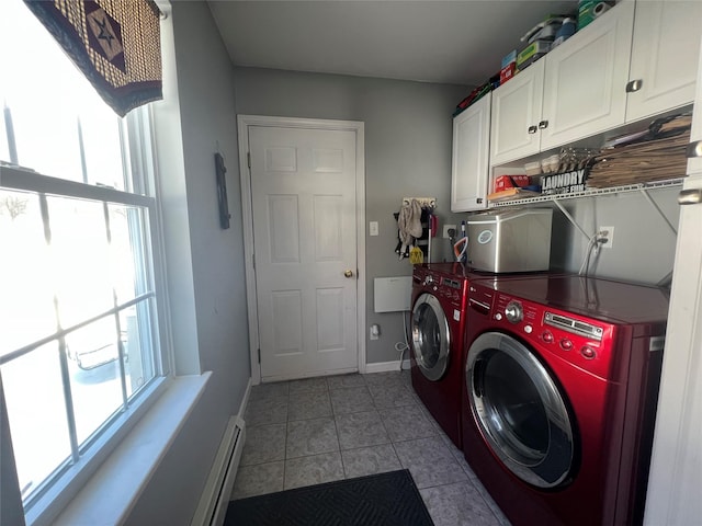 clothes washing area with a healthy amount of sunlight, cabinet space, light tile patterned flooring, and independent washer and dryer