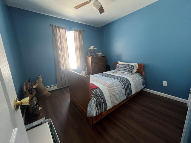 bedroom with a baseboard heating unit, dark wood-style flooring, a ceiling fan, and baseboards