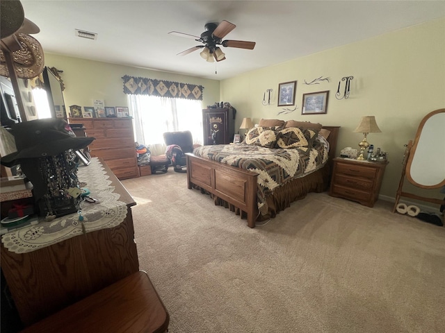 bedroom with light carpet, ceiling fan, and visible vents