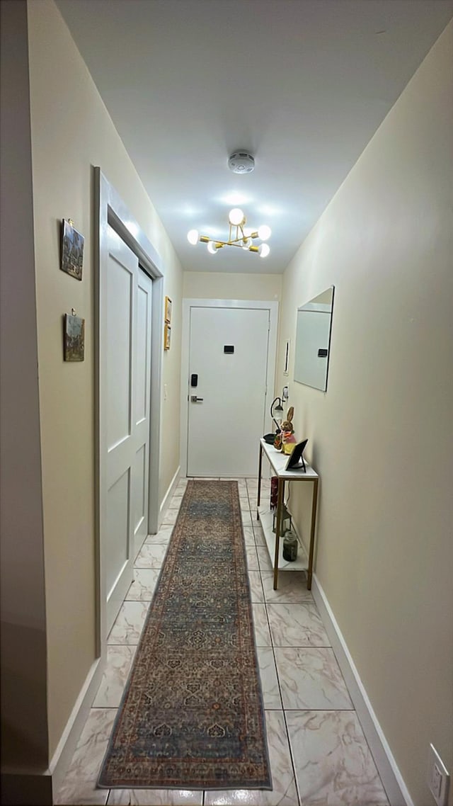 interior space featuring marble finish floor and baseboards