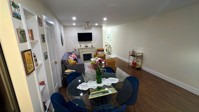 interior space with dark wood-style floors, recessed lighting, a fireplace, and baseboards