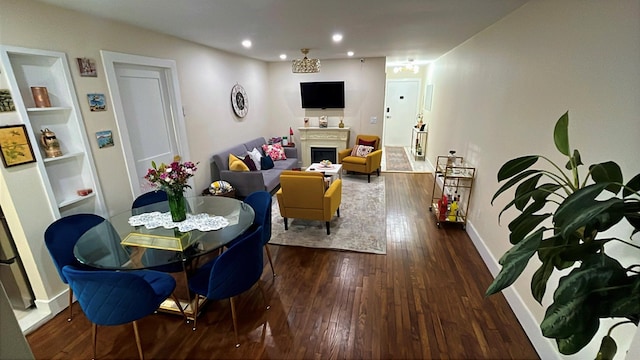 living room with dark wood-style floors, a fireplace, baseboards, and recessed lighting