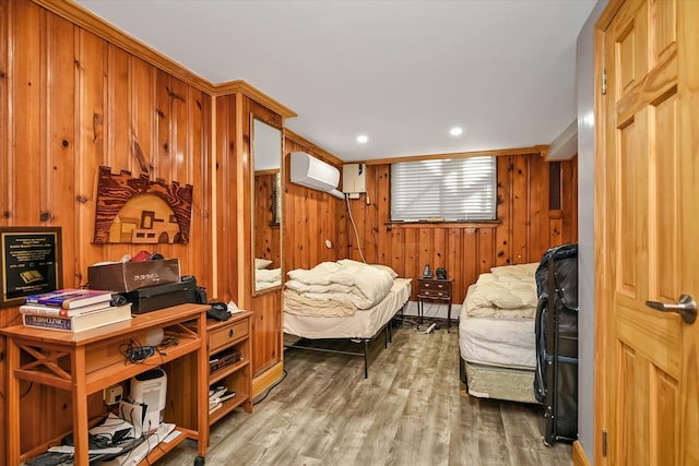 sitting room featuring a wall mounted AC, recessed lighting, wood finished floors, and wooden walls