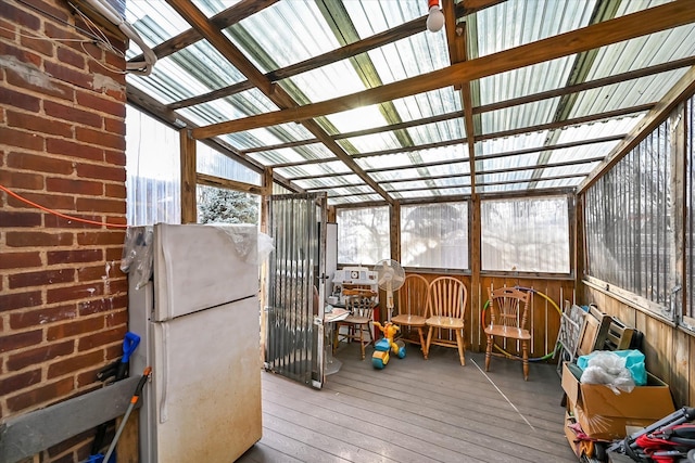 sunroom / solarium featuring lofted ceiling