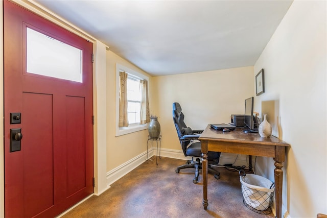 office featuring finished concrete floors and baseboards