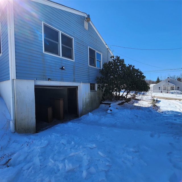 view of snow covered exterior featuring a garage