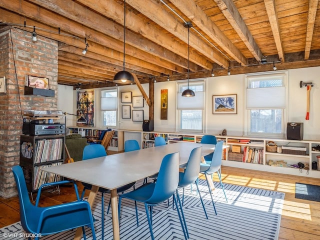 dining area with hardwood / wood-style flooring, wood ceiling, track lighting, and beam ceiling