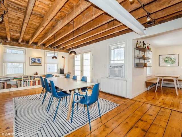 dining room featuring radiator, hardwood / wood-style flooring, wood ceiling, cooling unit, and beam ceiling