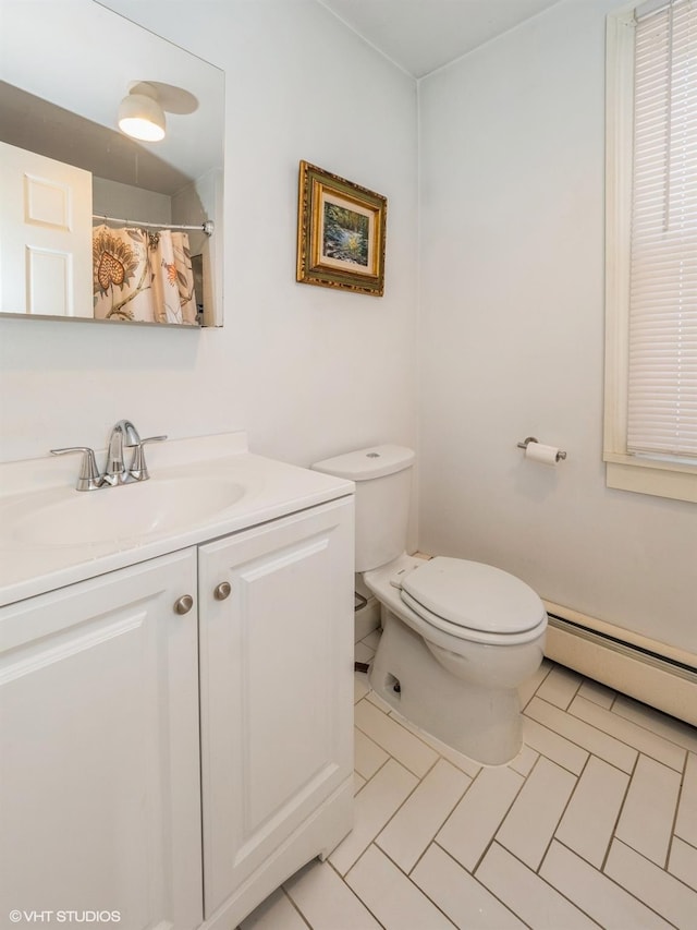 full bath featuring a shower with shower curtain, a baseboard radiator, vanity, and toilet